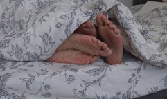 TWO PAIRS OF LEGS UNDER THE BLANKET