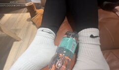 Ugg boots, black leggings and white Nike socks ,playing with a bottle with my feet