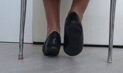 Play of shoes and bare feet under the chair a