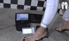 Electronic devices crushed under heeled Flip Flops