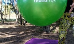 jump on green yogaball in forest