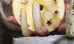 A GAINT WOMAN WITH LONG CLAWS AND TINY HUMAN