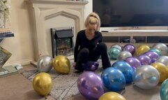 Chrome balloons sit popping