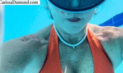 Carissa in the pool at the resort; swimming and blowing bubbles