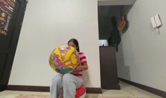 Akina blows a small beach ball