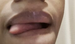 Sticking out Long Tongue and licking Glossy Lips