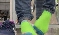 In public holey sock shoe and sock removal