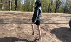 A girl in ballet flats walks through the wet spring mud, into which the ballet flats sink deeper step by step
