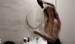 Blow drying, oiling and combing long blonde hair
