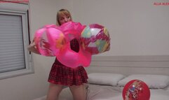 Alla inflates three beach balls and an inflatable ring with her mouth