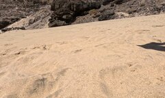 Naked girl lies on the sand and pee