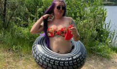 Girl on beach blowing big balloon with nailpop