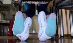 Shoeplay with white sneakers under the chair