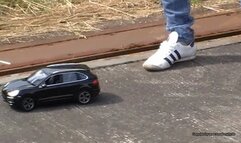 toy car crush in adidas aditrack white sneakers