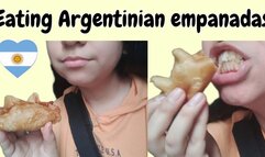 Eating and loud chewing Argentinian empanadas