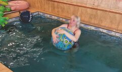 Alla plays with two beach balls in the pool
