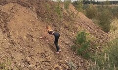 A girl in high-heeled shoes She tries to climb a steep slope, but she can't (short version)