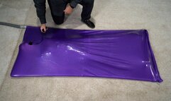A girl experiences an orgasm in a lilac vacuum bed with an inflatable gag in her mouth