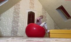 Alla happily jumps on huge black and red fitness balls