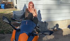 Alice smokes a cigarette while posing on her motorcycle (4k)
