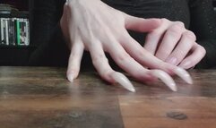 3 cm natural claws scratching wooden table