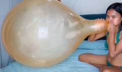 Sexy Camylle Blows To Pop Yoiur Huge Orange Belbal 24 Inch Balloon In A Green Bikini