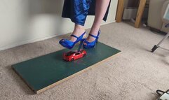 Giantess Lily Kink toy car crush of a 2017 BMW I8 in big blue heels Left view