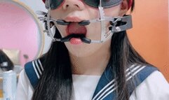 A beautiful and lovely Asian girl had her mouth stretched open and kept drooling.