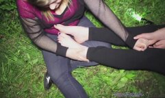 Luna Rubbing Alissa's Feet on dark wooded trail