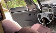 Jarlyn has trouble driving her Volkswagen Beetle on her way to work.