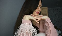 Hands with long nails under the chin