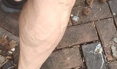 Flexing in black sneakers on cobblestone