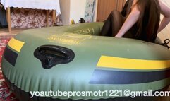 Nastya in black tights tramples on a large inflatable boat, steps with all her weight, presses, walks, beautiful legs, ass