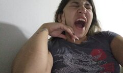 Lola yawns while smoking her cigarette