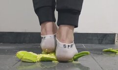 Guy crushing zucchini in ankle white socks