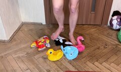 a girl in shorts and a bra tramples various inflatable toys, steps on them and sits down. crash fetish foot fetish