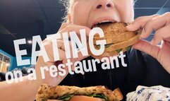 Devouring a sandwich on public