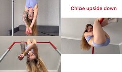 Chloe is hanging upside down, her hands bound and her mouth taped shut
