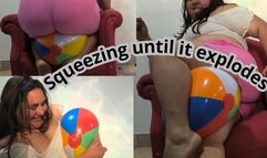 Small beach ball squeezing until it explodes