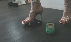 Giantess goddess Charlie Caroline Crushes a 2 Chevrolet Corvette's in gold strappy heels with painted toenails low close right view