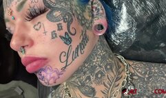 Australian bombshell Amber Luke gets a new chin tattoo