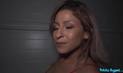 Pretty woman wearing a tiny red dress and standing on the street corner