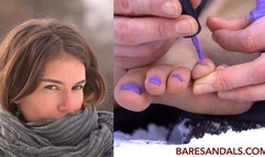 Teresa applies nail polish to her toes outside in the snow - 12400