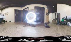 Putting on her green tights on the bed