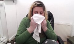 Nose blowing into hanky green hoodie