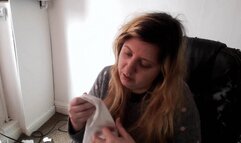 Nose blowing into hanky in jumper