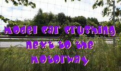 Model car crushing next to the motorway
