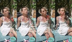 Chain-smoking outdoors in short White dress