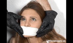 Attractive secretary Andie Valentino struggled vigorously on the floor of her office after she was tied up and tape-gagged!