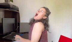 sits at the workplace and yawns